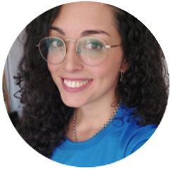 Miembro de Nuestro Equipo sonriendo con gafas y pelo rizado.